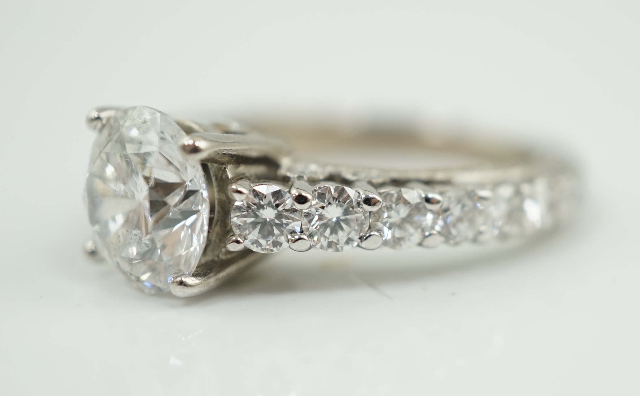 A modern 18ct white gold and single stone diamond set ring, with twenty eight graduated diamond set shank and setting